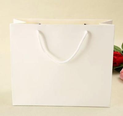 China Custom Luxury Gift Garment Paper Shopping Bags With Logo Print for sale