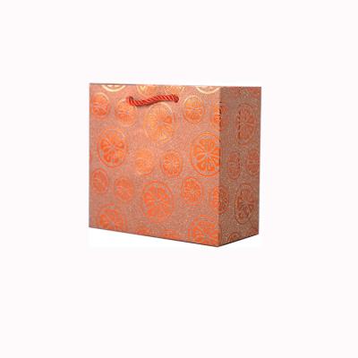 China Handmade Orange Pattern Paper Gift Bags With Logo 210gsm Black Gift Bag With Ribbon Handle for sale