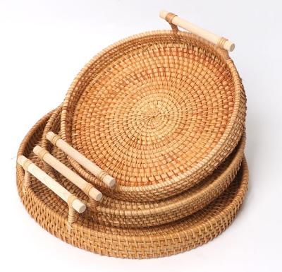 China Sustainable rattan around serving tray and hand - woven serving basket with cutout handles for sale