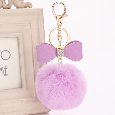 China Cute Custom Colorful Plush Faux Fur Pom Pom Fast Delivery Key Chain With Bowknot for sale