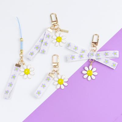 China Promotion Gift Daisy Flower Ribbon Keychain Alloy Hyuna Airpods Bluetooth Earphone Set Bag Pendant for sale