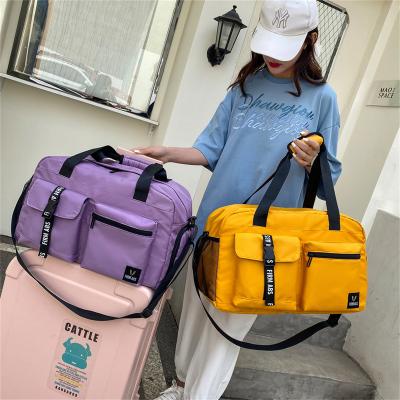 China Durable New Fluorescent Color Luggage Duffle Bags Waterproof Large Capacity Tote Handbag Portable Sports Travel Bags Woman Men for sale