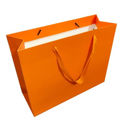 China Recyclable Manufacturer Gift Packaging Bag Orange Kraft Paper Shopping Bag With Your Own Logo for sale