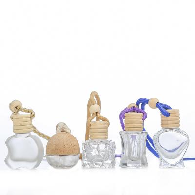 China 5ml 8ml 10ml Luxury Wholesale Diffuser Car Perfume Empty Glass Hanging Bottle With Cap Air Freshener Glass Wooden Bottle for sale