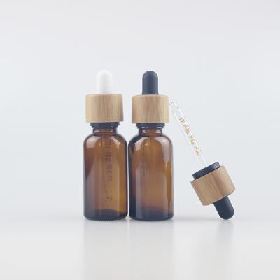 China Wholesale Child Safe 18mm Glass Dropper Cap With Bamboo Lid For Essential Oil 30ml Amber Bottles for sale