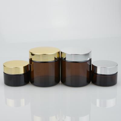 China OEM 20ml 30ml 50ml 100ml Skin Care Cream Clear Amber Cosmetic Cream Glass Jar With Gold And Silver Lid for sale