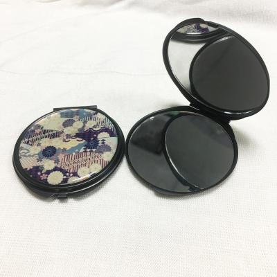 China Metal Makeup Magnifying Portable Hand Mirror Around Black Compact Mirror Mini Pocket Mirror Gun for sale