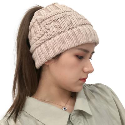 China JOINT Crisscross Acrylic Custom Knit Women's Leather Knit Ponytail Beanie Hat 2020 Women Chunky Warm Knitted Winter Crochet Hat for sale