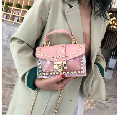 China Luxury Clear Rivet Jelly Transparent Tote Purses Of Candy Color Fashion Hot Sale PVC Handbag For Women for sale