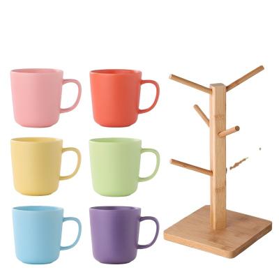 China Macaron Viable Creative Simple Color Fashion Breakfast Milk Coffee Water Ceramic Cup 6 Cup Sets With Wooden Stand for sale