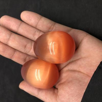 Cina Hot Sale Wholesale Yoni Crystal Eggs Orange Cat Eye Crystal Eggs from China in vendita