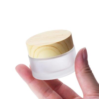 China 5G 10G 15G 30G 50G 100g Personal Care Cream Jar Packaging Empty Frosted Glass Cosmetic Containers With Wood Grain Cover for sale