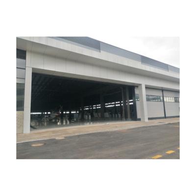 China Contemporary high quality steel structure aircraft hangar with small sectional and fast lifting gear hangar door for sale