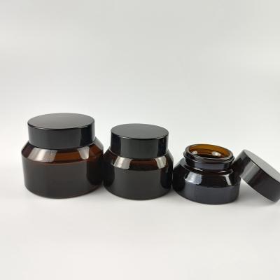 China 15g 30g 50g Amber Sloping Shoulder Glass Cosmetic Cream Jars With Black Plastic Lids for sale