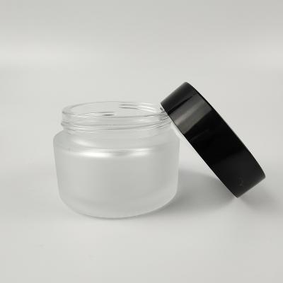 China 5g 10g 15g 20g 30g 50g 100g Clear Frosted Glass Cosmetic Empty Cosmetic Jars With Black Plastic Lids for sale