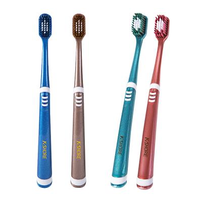 China Soft Non-slip Adult Volcanic Carbon Handle Soft Toothbrush Wire Whitening Teeth Protecting Erasers Toothbrush for sale