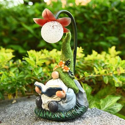 China Eco-friendly Garden Summer Gnome Resin Gnomes Figurine Solar Reading Book With Solar Powered LED for sale