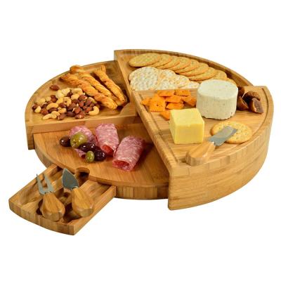 China Sustainable Luxury Patented Natural Bamboo Round Cheese Deli Board With Pull Out Knife Set Storage Knives Foldable for sale