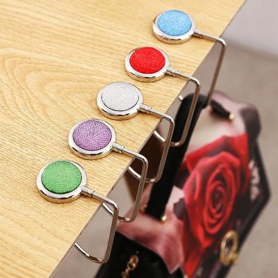 China Creative Portable Metal Bag Purse Hook Hanger Purse Hanger Purse Hook Handbag Foldable Stand Shell Bag Folding Table Hook 10 Colors for sale