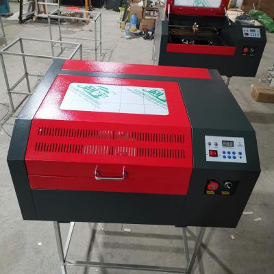 China Laser Engraving CO2 4040 50w Laser Cutting Machine With Electric Across Table for sale