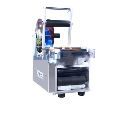 China CLOTHING manual labeling machine, round bottle labeling machine, sticker machine with coding for sale