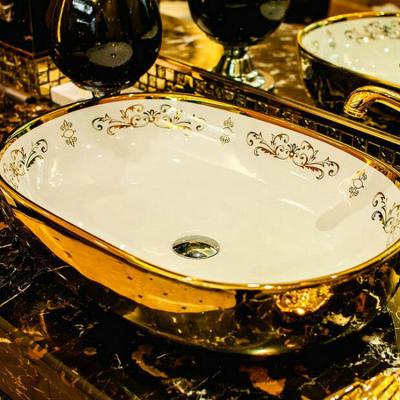 China Luxurious Oval Bathroom Vessel Sink Countertop Gold Ceramic Wash Basin Gold for sale