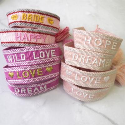 China Bohemia Moyamiya 100 plus handmade wrist band in stock text logo bracelet custom tassel woven friendship bracelet for sale