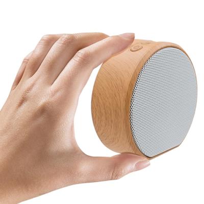 China No low cost event party gift custom logo printed wood grain A60 mini round wireless speaker for sale