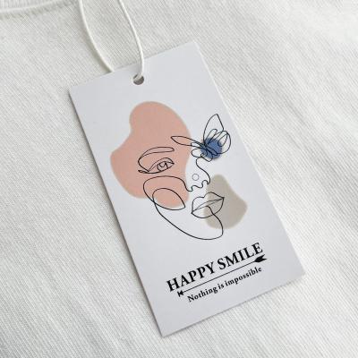 China Cheap CLOTHING Hang Swing Tags Design Custom Printed Logo Paper Hang Clothing Tags and hangtags for jeans for sale