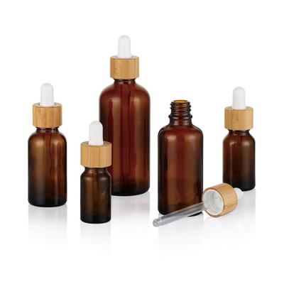 China 10ml-100ml Essential Oil Bottle 50ml Bamboo Lid White Porcelain/Amber Platinum Essential Oil Bottle Anti-theft Cap for sale