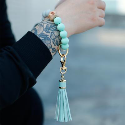 China Bohemia INS Amazon New Hot Selling Customized Multiple Wooden Tassel Bracelet Bead Silicone Food Grade Pearl Style Key Chain For Women for sale