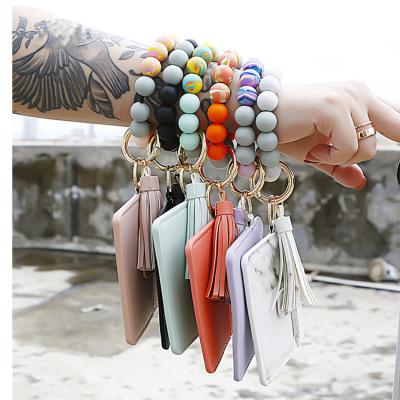 China Bags Unique Silicone Bead Bracelet Key Chain PU Leather Bag Tassel Wrist Bracelet Keychain Beaded Bracelet Key Chain for sale