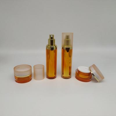 China Wholesale Cosmetic Packaging Luxury Orange Cylindrical Acrylic Bottles And Jars for sale