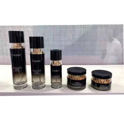 China Newest Personal Care Cosmetic Packaging Set Luxury Black Glass Lotion Pump Bottle Gold And Silver Jar 30ml 50ml Glass Pump Bottle for sale