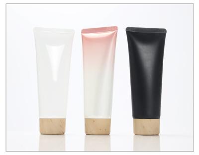 China 50ml 100ml Plastic Cosmetics Empty Tube Plastic Tube Packaging With Wooden Grain Caps Subpackage For Body Lotion And Detergent for sale