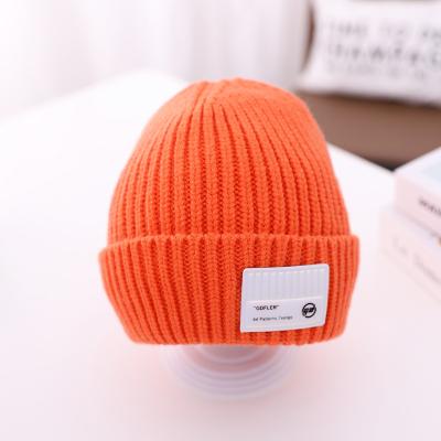 China Custom cute JOINT solid color label logo knitted warm beanie hat for babies kids skull cap winter hats for sale