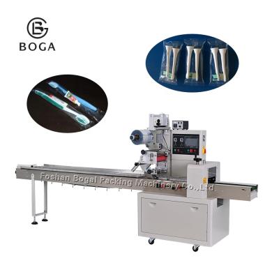 China Automatic Pillow Wrapping Machine Disposable Toothpaste Toothbrush Comb Packaging for sale