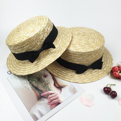 China Sun Beach Straw Hat Fashionable Mummy Kids Bowknot Natrue Hats Grass Real Straw Hat For Summer 2023 for sale