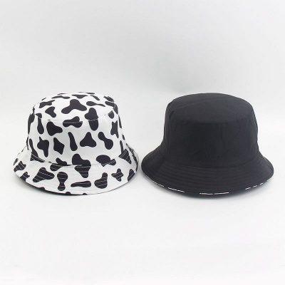 China New Reversible Fashion Black Character Fashion Cow Print Bucket Hat White Summer Sun For Women Men Fisherman Hat for sale