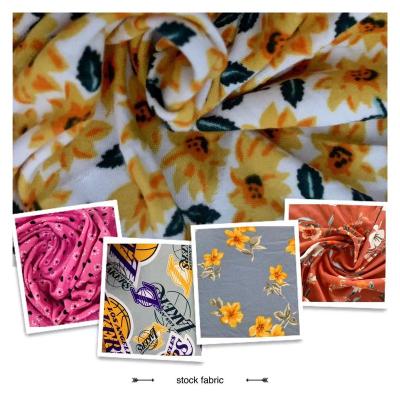 China Anti-Static Fabric Stocklots tela Jersey Knitted DTY Mixed Designs Double Brush Print Stock Fabric for sale