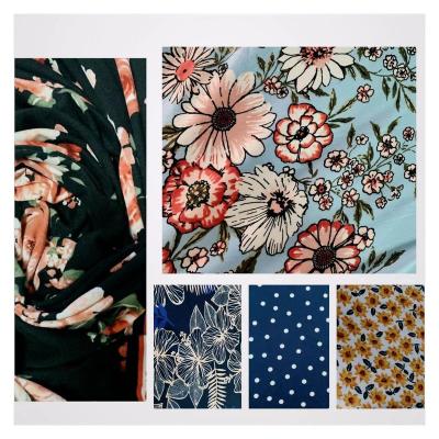 China Quality Stocklots fabric tela anti-static jersey knitted DTY mixed designs double brush print stock fabric for sale