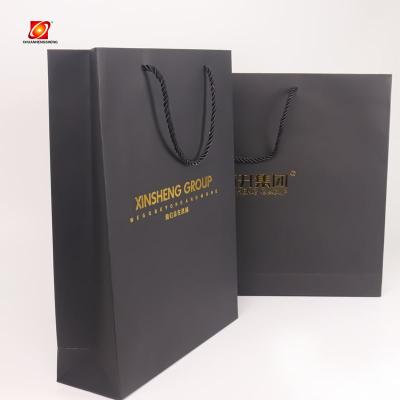 China Recycled Materials Professional Kraft Shopping Clothes Cardboard Custom Paper Bag for sale