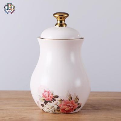 China Viable exquisitely made hot sale cream and gold canister ceramic airtight storage jars spice jar with flower for sale