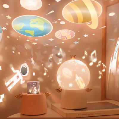 China Kids Modern Cartoon Rotating Night Light Gifts For Kids Music Box LED Space Projector Lamp for sale