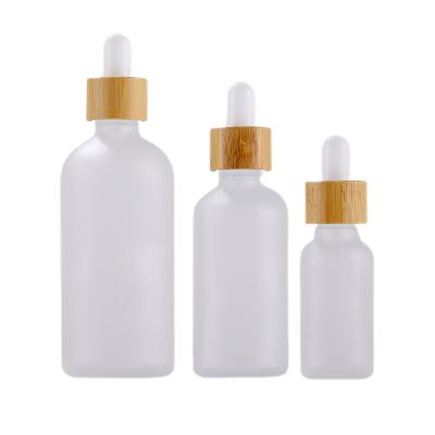 China 5-100ml Glass Cosmetic Widely Used Essential Oil Bottle With Bamboo Dropper Cap for sale