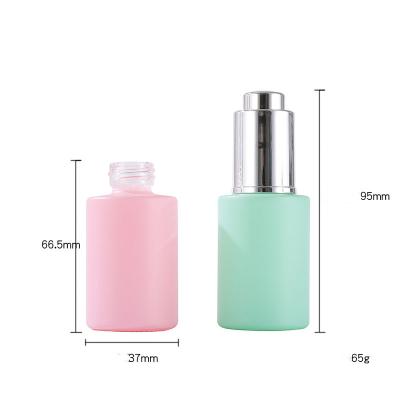 China Essential Oil Cosmetic Flat Cosmetic Serum Shoulder Press Pump Glass Dropper Bottle With Press Dropper for sale