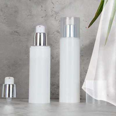 China 80ml 100ml Cosmetic Cylindrical Skin Care Serum Face Cream White Plastic PP Vacuum Pump Bottle With Shiny Silver Airless Lotion Pump for sale