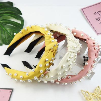 China Popular Solid Color Headband Fabric Art Solid Color Pearl Knotted Hair Ornaments Soft Full Bow Knot Headband for sale