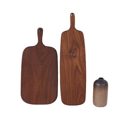 China Sustainable Stock Kids Food Extra Walnut Wooden Cutting Board With Handle for sale