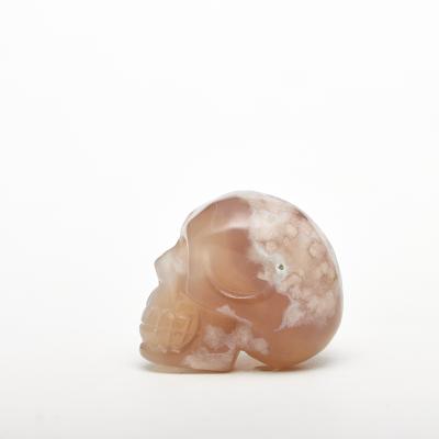 China Natural fengshui crystal stone and china oriental cherry agate skull healing crystal healing stones for decoration and gifts for sale